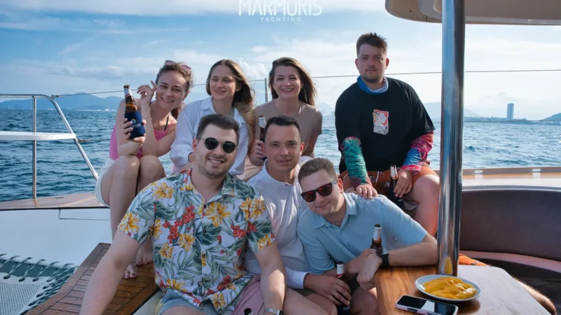 Travelers taking photos on a luxury yacht in Nha Trang, reflecting different vacation styles from relaxation to luxury travel.