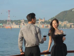 Couple admiring the evening light over the sea before sunset