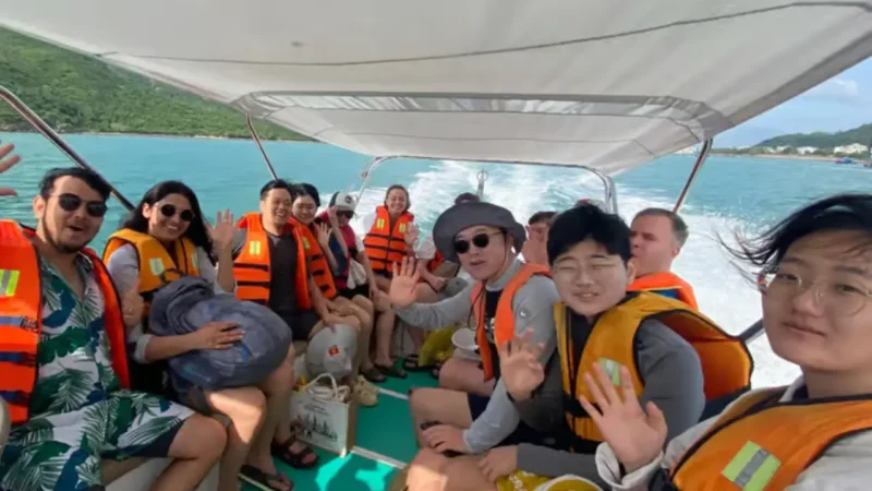 Foreign and Vietnamese travelers enjoying a shared group tour in Nha Trang together