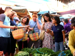 Happy visitors exploring a local market in Nha Trang early in the morning