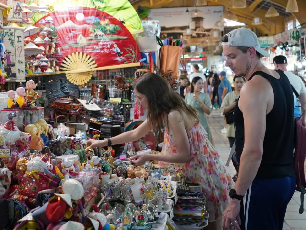 Visitors purchasing traditional souvenirs during a market visit Visitors purchasing traditional souvenirs during a market visit