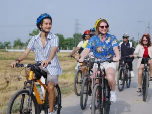 Guests riding bicycles through local villages during a Sea You Travel tour