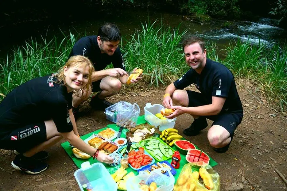 Picnic Lunch by Stream During Da Lat Canyoning Travelers enjoying a picnic lunch beside a stream during the canyoning tour in Da Lat